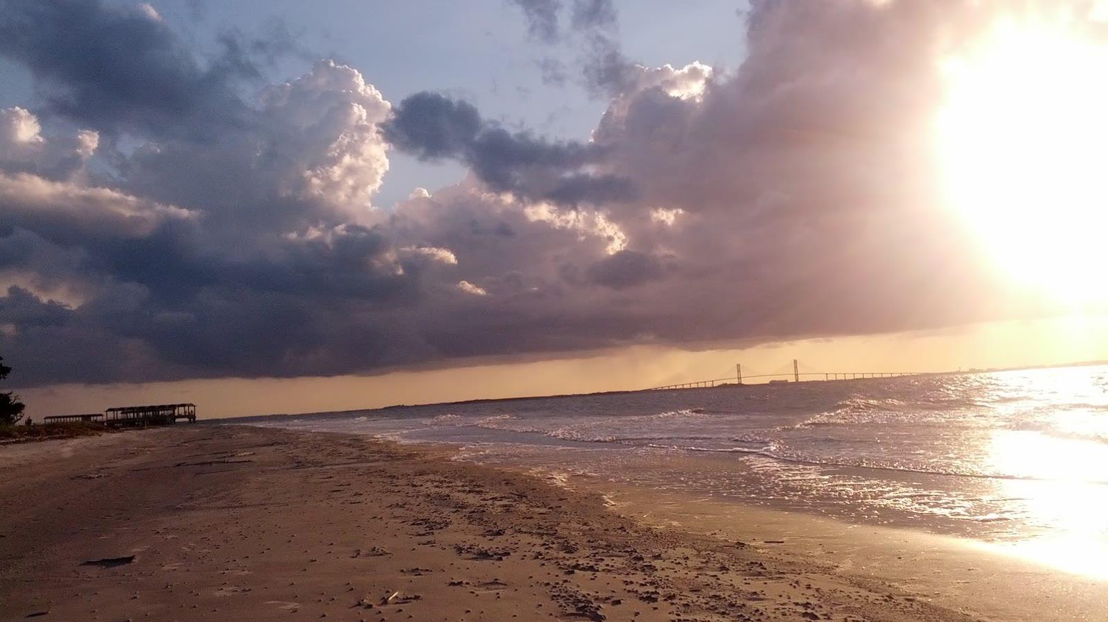 The wide sand and shallow water of a Jekyll Island shore under a Georgia sky