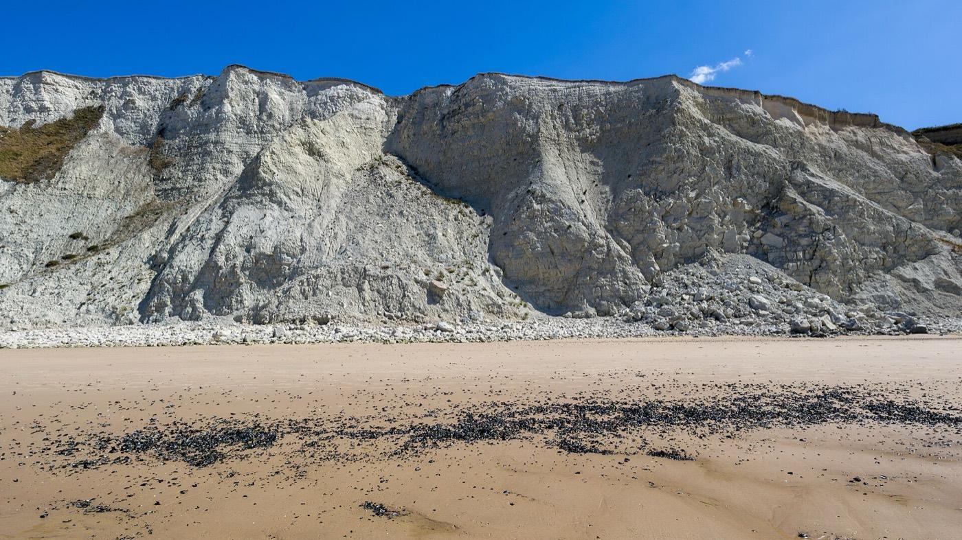 The white chalk cliff face of Cap Blanc-Nez above the beach