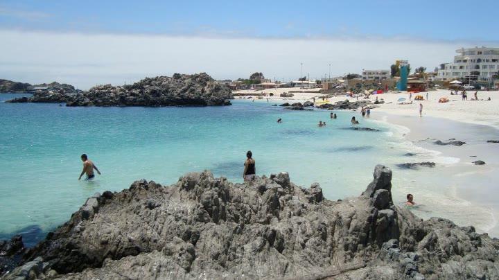 The turquoise water and dark rock of the coast at Bahía Inglesa in the Atacama Desert