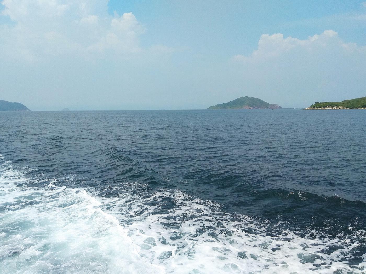 Port Island seen across the water from the south-east, its red rock low against the sea