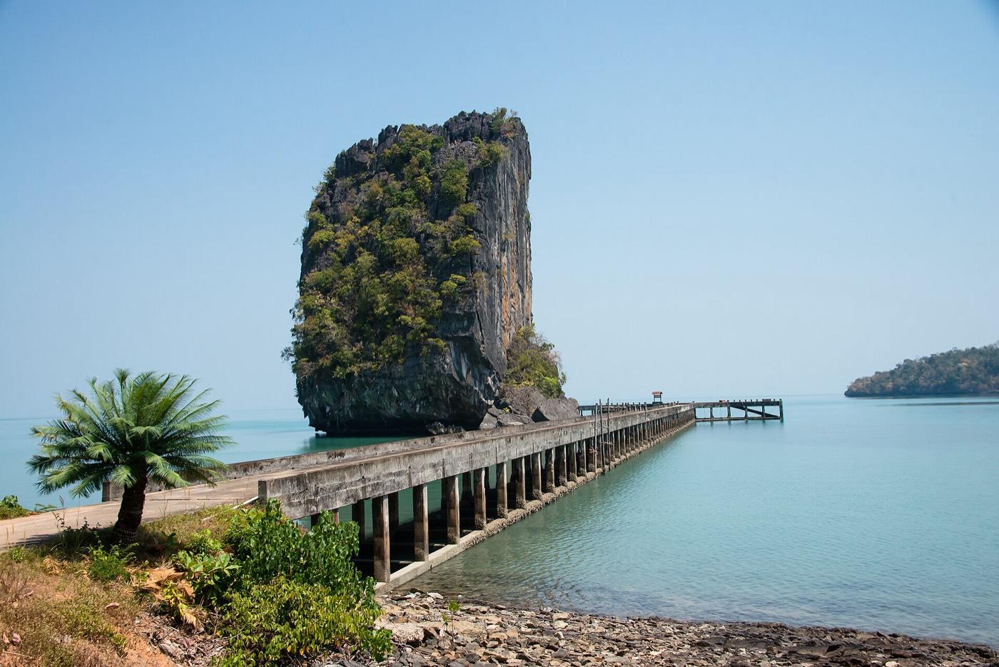 The pier at Ao Ta Lo Woo on Ko Tarutao, limestone cliffs rising behind it