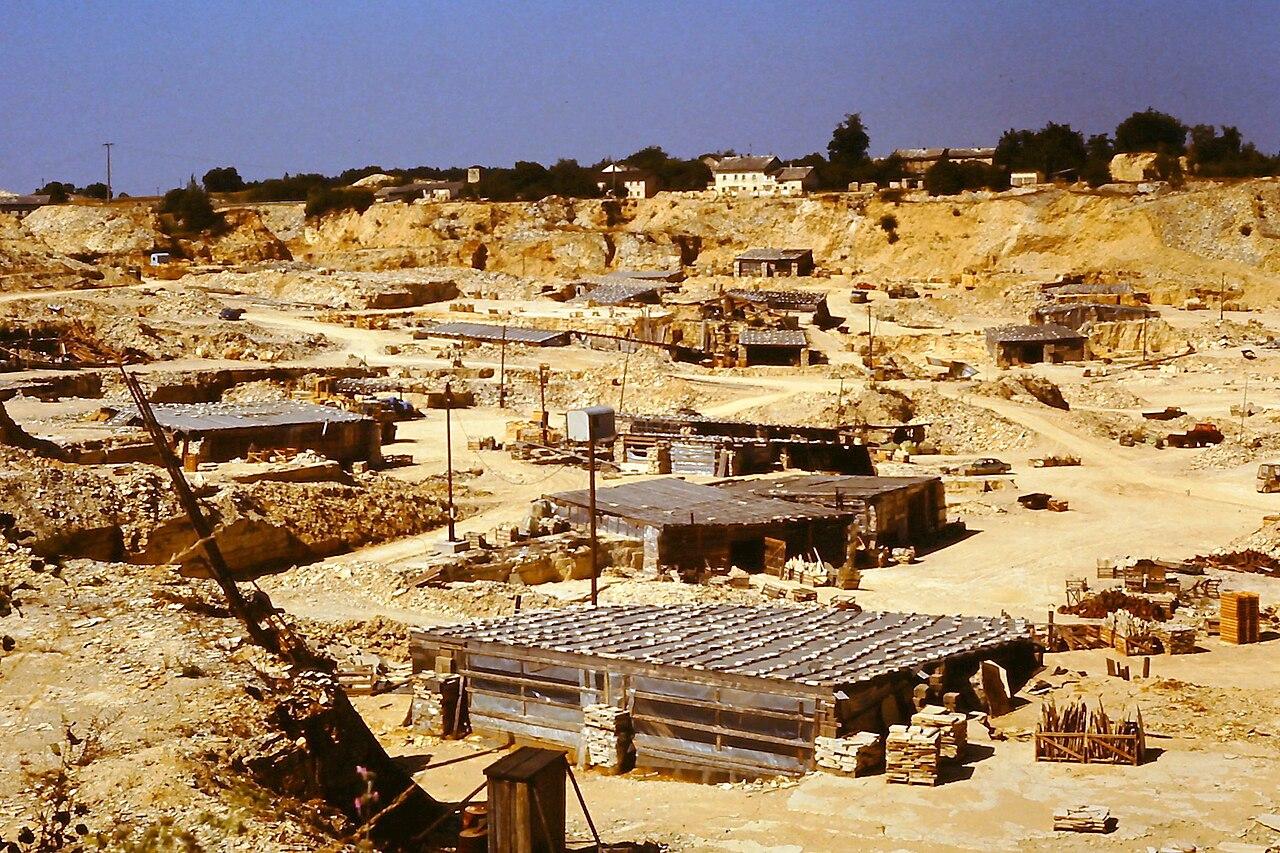 The Solnhofen quarry, its pale limestone worked into flat tabular slabs stacked across the floor
