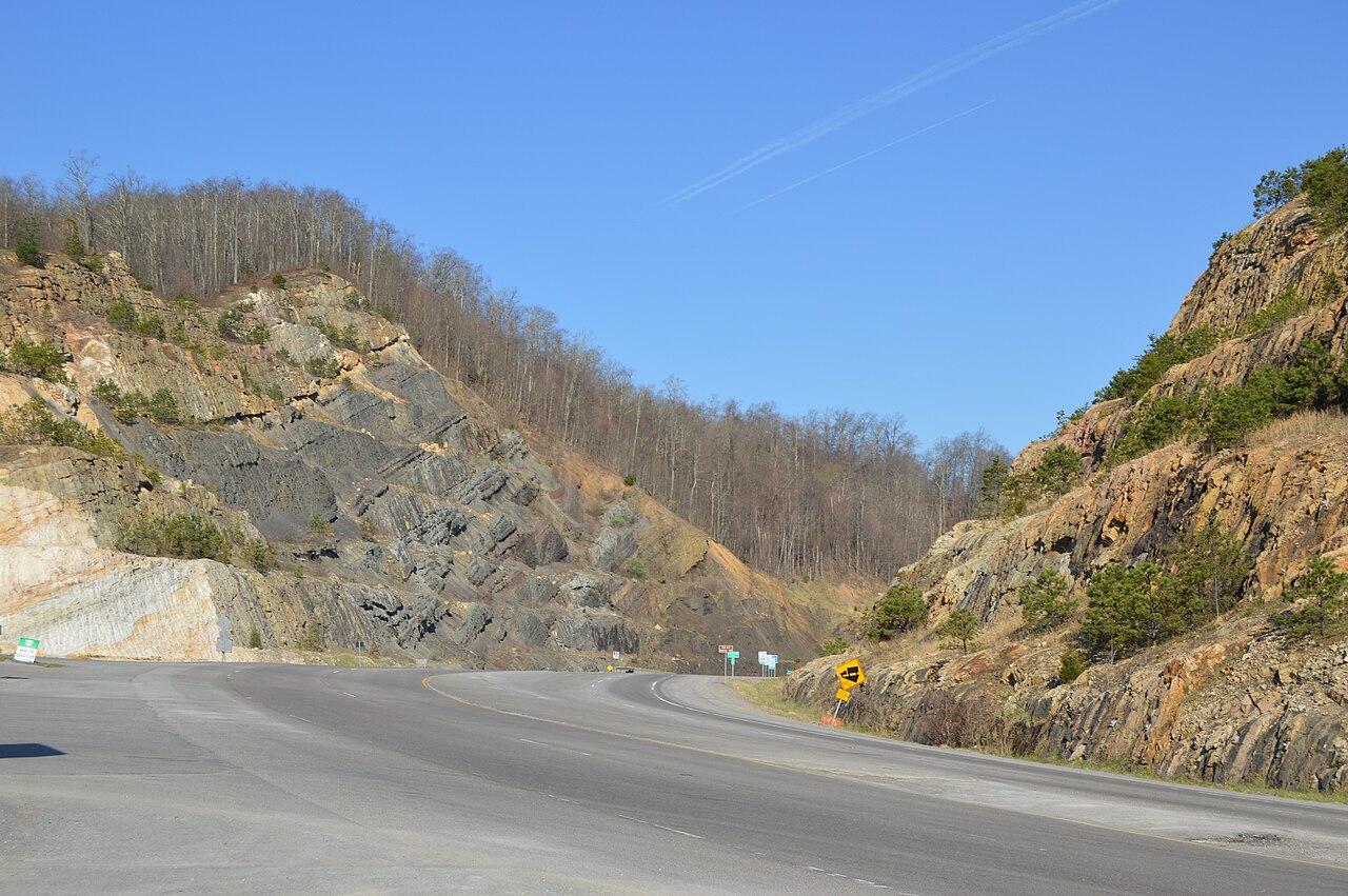 Flat-lying shale and sandstone beds exposed in the deep highway cut at Pound Gap, Kentucky