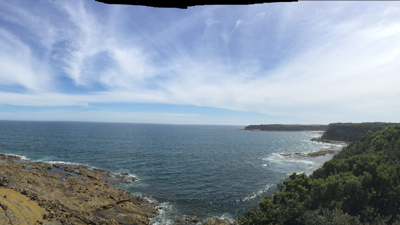 Panoramic clifftop view across rocky platforms and the ocean at Eagles Nest, Cape Paterson, Victoria, Australia.
