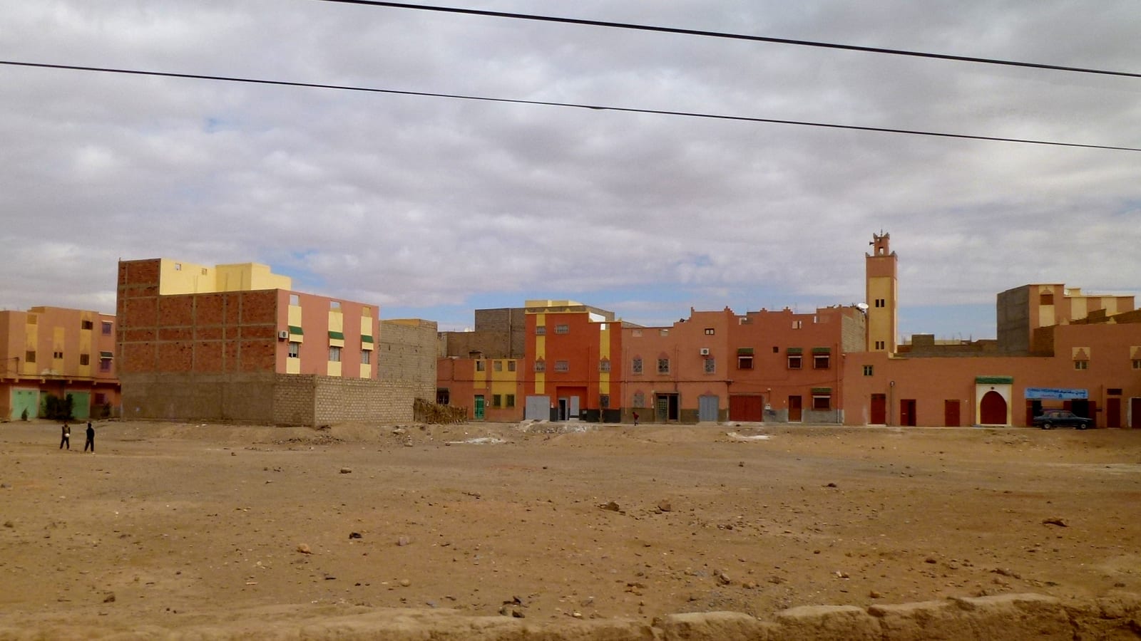 Low ochre buildings and a minaret on the desert edge at the town of Erfoud, Morocco, near the orthoceras quarry.